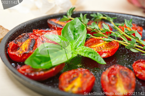 Image of baked cherry tomatoes with basil and thyme