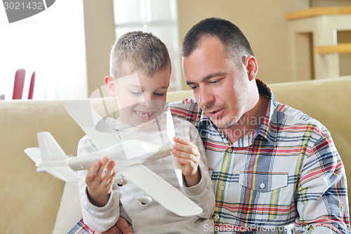 Image of father and son assembling airplane toy