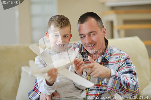 Image of father and son assembling airplane toy