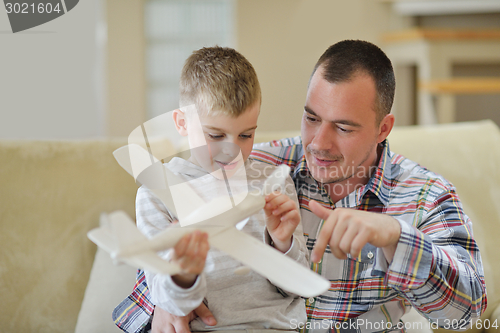 Image of father and son assembling airplane toy