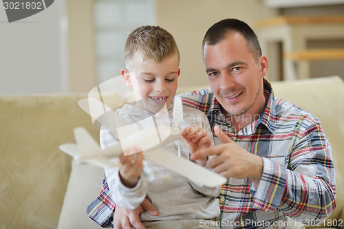 Image of father and son assembling airplane toy