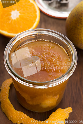 Image of glass of pear jam with orange