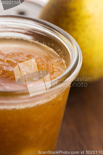 Image of glass of pear jam with orange