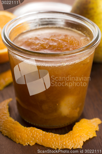 Image of glass of pear jam with orange