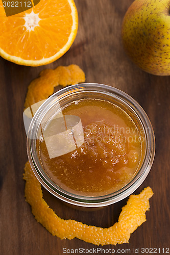 Image of glass of pear jam with orange