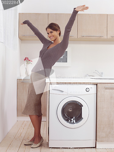 Image of pretty smiling girl in the laundry room lhk