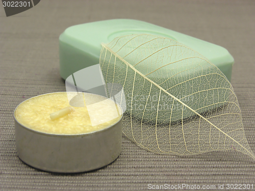 Image of Green soap with decoration articles on a  gray  background