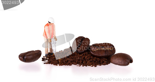 Image of Miniature worker working on a coffee bean