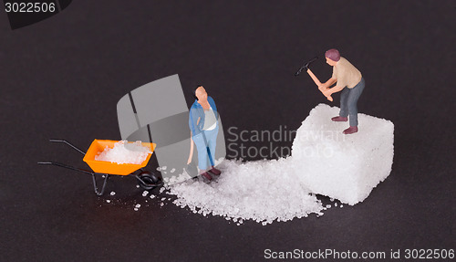 Image of Miniature worker working on a sugar cube