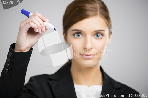 Image of Businesswoman drawing on a glass board