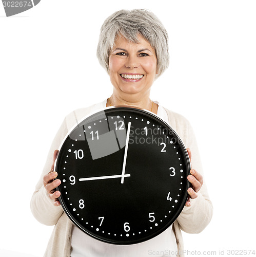 Image of Elderly woman holding a clock