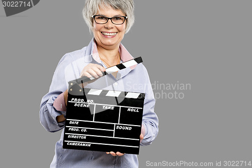 Image of Elderly woman holding a clapboard