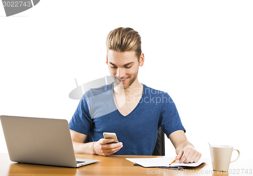 Image of Young man sending text messages