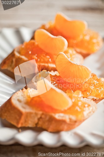 Image of pieces of baguette with orange marmalade