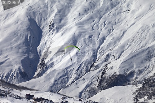 Image of Speed flying in snow mountains in sunny nice day