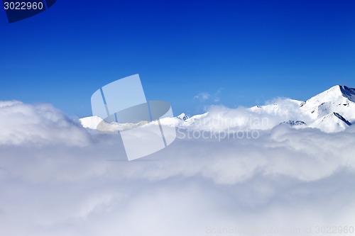 Image of Mountains under clouds in sun day