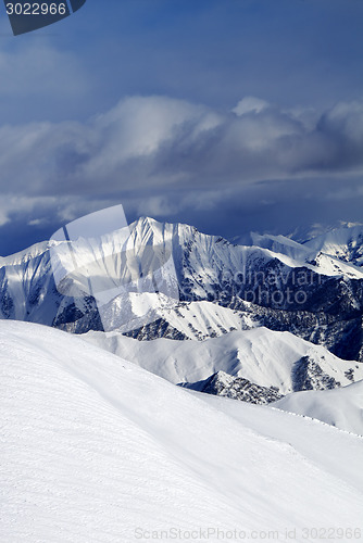 Image of Off-piste snowy slope and cloudy mountains