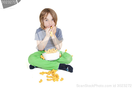 Image of boy eats peanut chips
