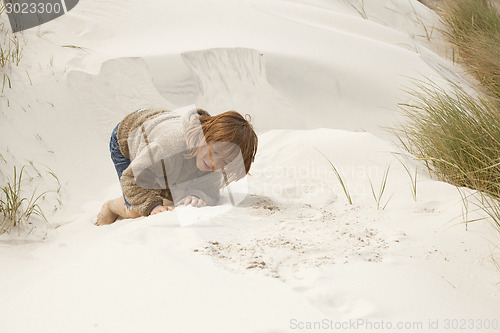 Image of boy playing in the dunes