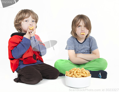 Image of two boys with peanut puffs