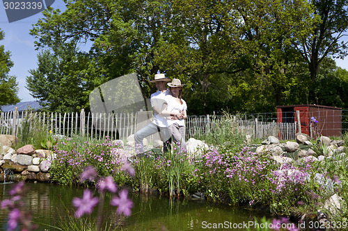 Image of couple embracing at the pond