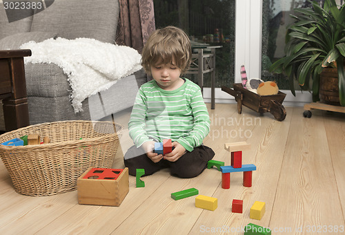 Image of boy playing with wooden blocks