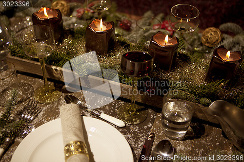 Image of christmas laid table in the candlelight