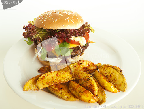 Image of cheeseburger with potato wedges 