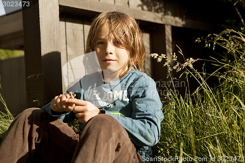 Image of boy sitting in the garden