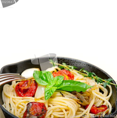 Image of spaghetti pasta with baked cherry tomatoes and basil 