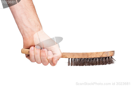 Image of Isolated steel brush in male hand