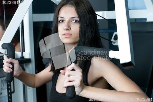 Image of Young woman in sport club