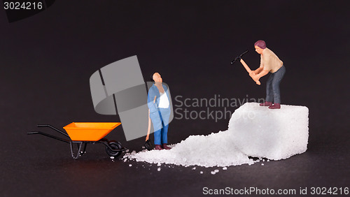 Image of Miniature worker working on a sugar cube