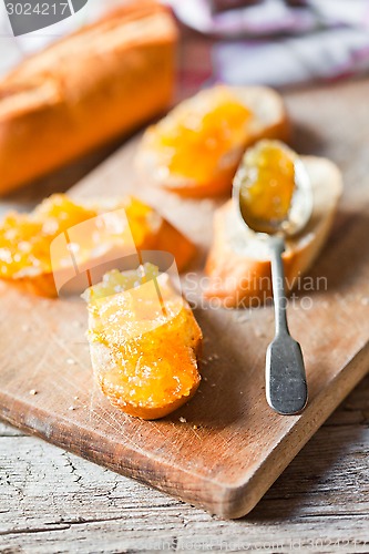 Image of pieces of baguette with orange marmalade 