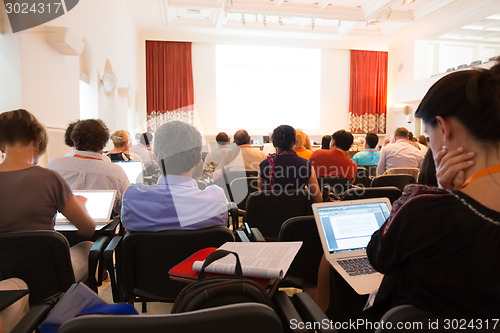 Image of Speaker at Business Conference and Presentation.