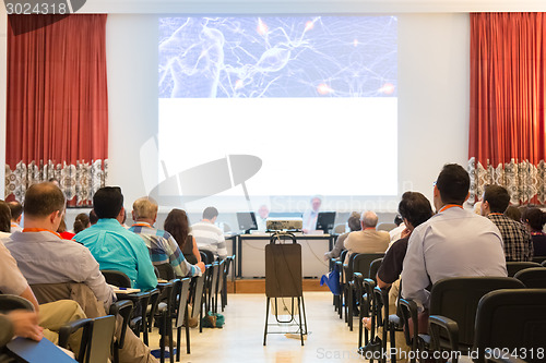 Image of Speaker at Business Conference and Presentation.