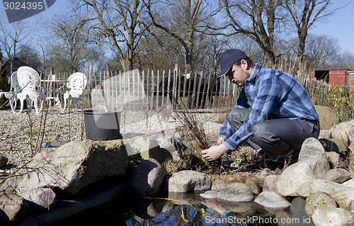 Image of Man cleans creek