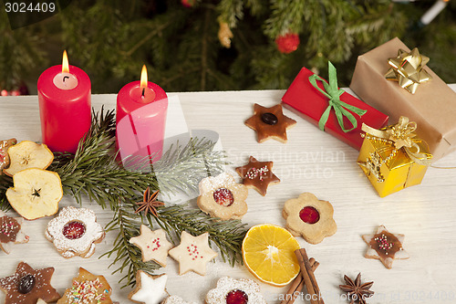 Image of table with gifts and christmas candles