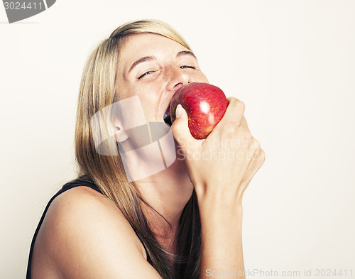 Image of Woman biting on apple