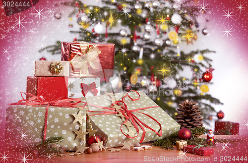Image of Gifts and Christmas tree with red glittering background