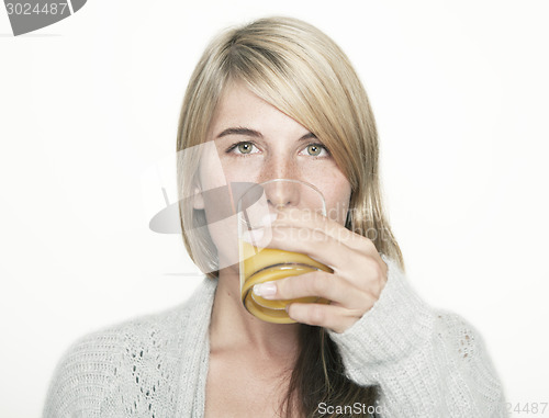 Image of woman drinking orange juice
