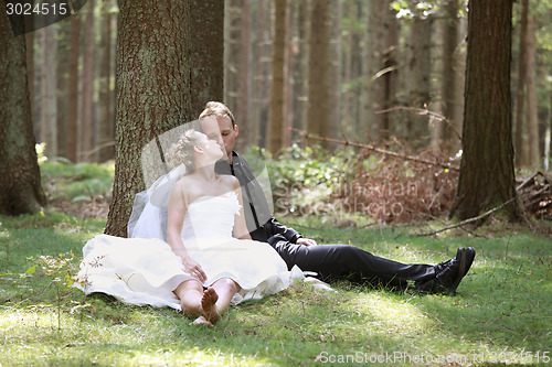 Image of Bride kiss in the forest