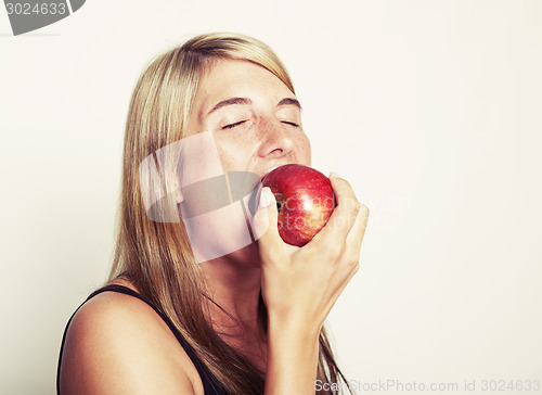 Image of Woman biting into apple