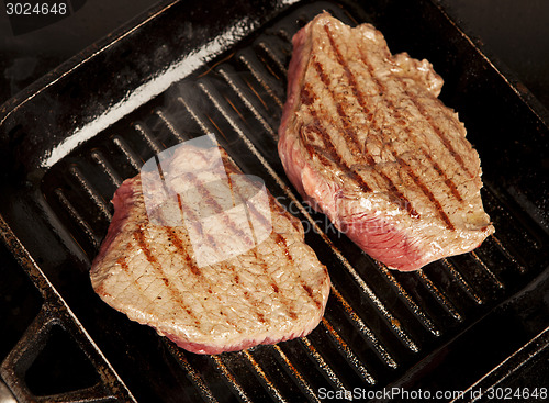 Image of two steaks in the pan