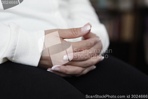 Image of Hands folded artificial fingernails