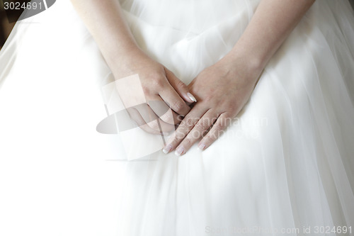 Image of wedding dress with hands