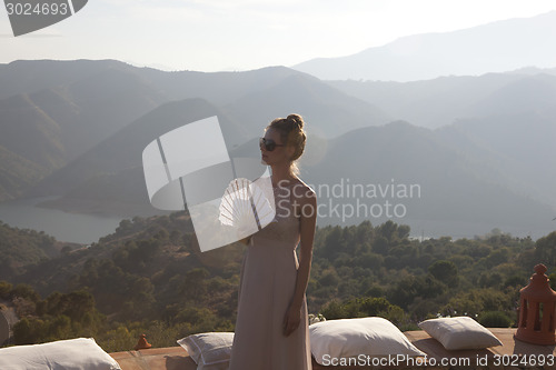 Image of beautiful woman on terrace