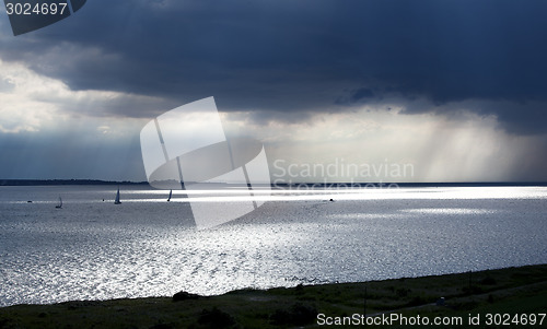 Image of boats under dark sky