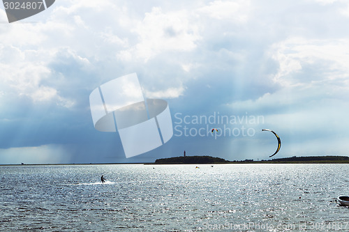 Image of sunbeam with kitesurfer