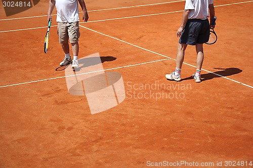 Image of Male couple playing tennis